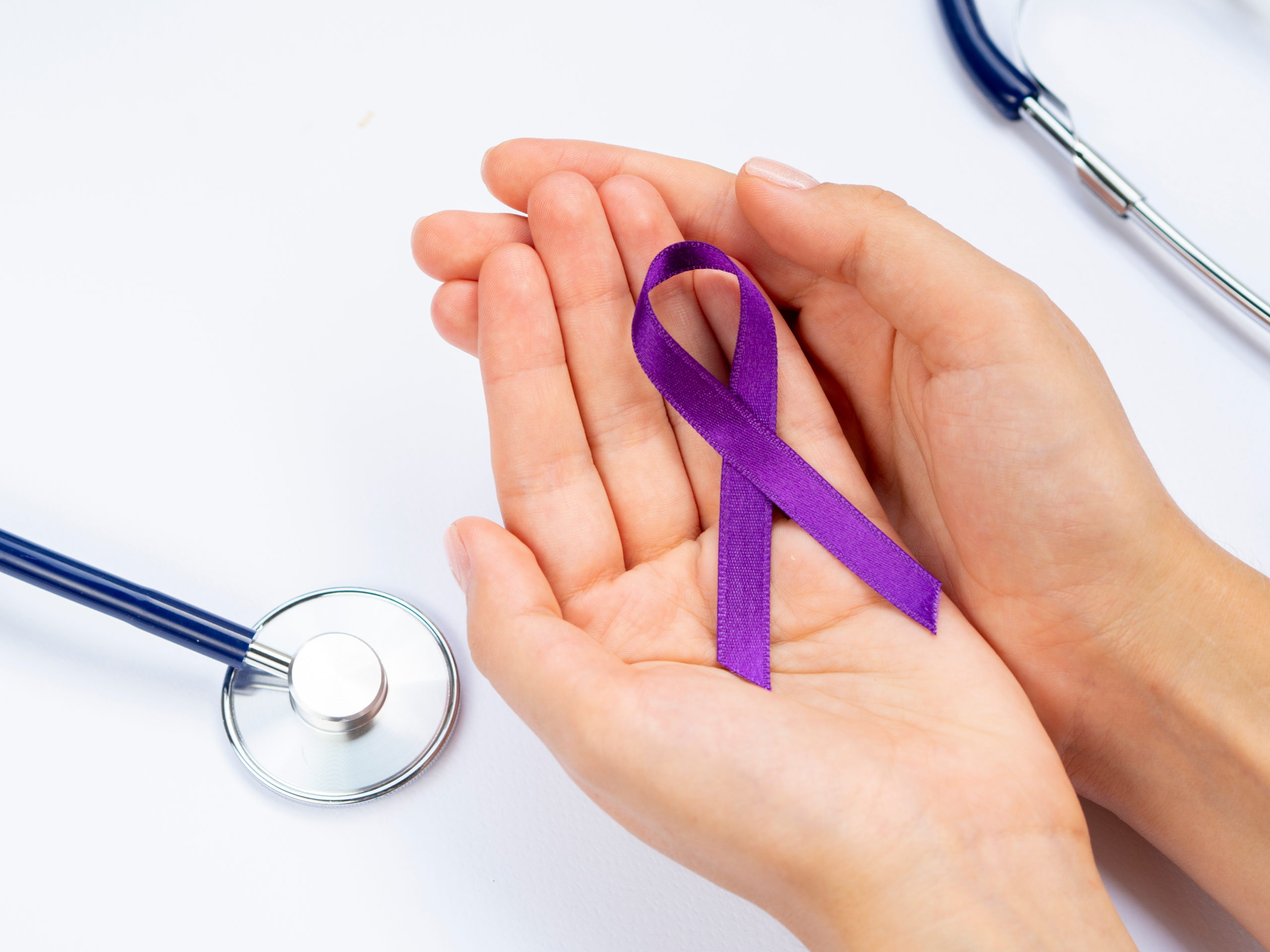 pancreatic cancer, hands holding a purple bow