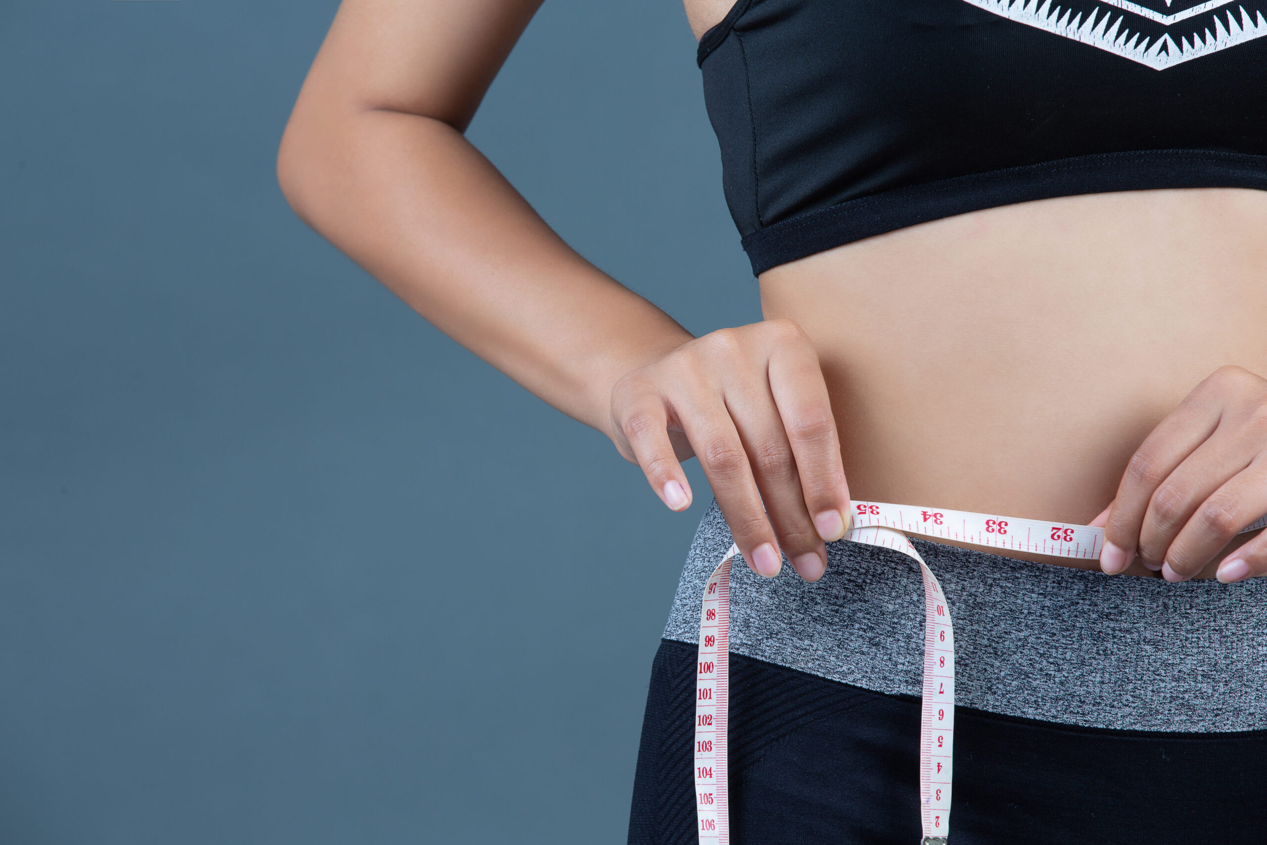 weight loss, woman measuring her waist